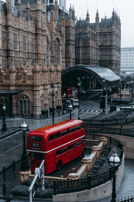 A close-up view of a black and red London Underground sign for Westminster Station, with the text 'Westminster Station' and symbols for toilets and public subway, mounted on an ornate black metal pole against the backdrop of historic buildings and the clock tower with Big Ben in the distance. The scene is outdoors with overcast skies, capturing the urban atmosphere of Westminster in London. Westminster Carpet Cleaning ensures thorough surface cleaning and sanitisation for residential and commercial properties in this area, maintaining hygiene and cleanliness standards.